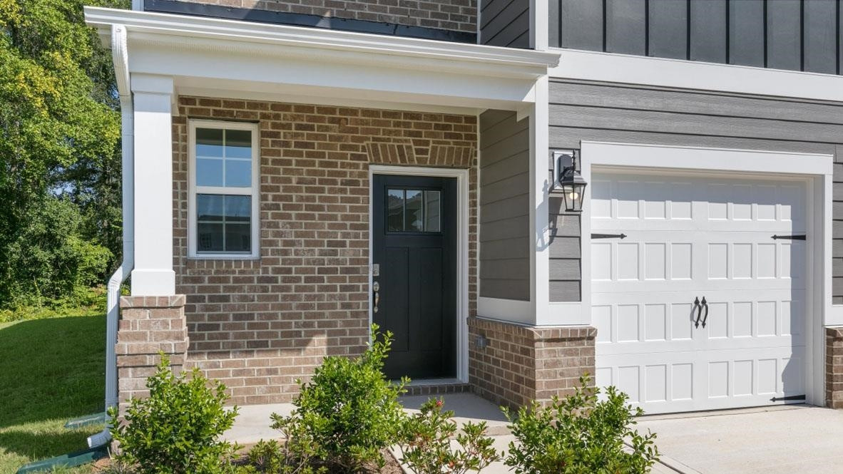 5129 Lizard Tail Lane Raleigh, NC 27603 - Photo 2 of 49 a front view of a house with a garden