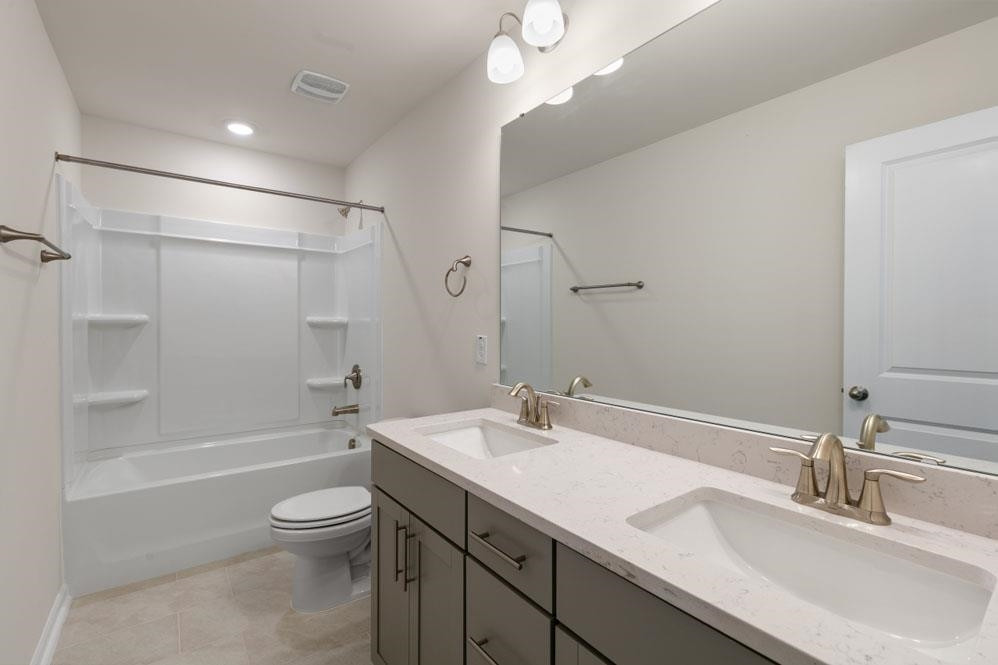 5129 Lizard Tail Lane Raleigh, NC 27603 - Photo 29 of 49 a bathroom with a granite countertop sink a toilet and shower