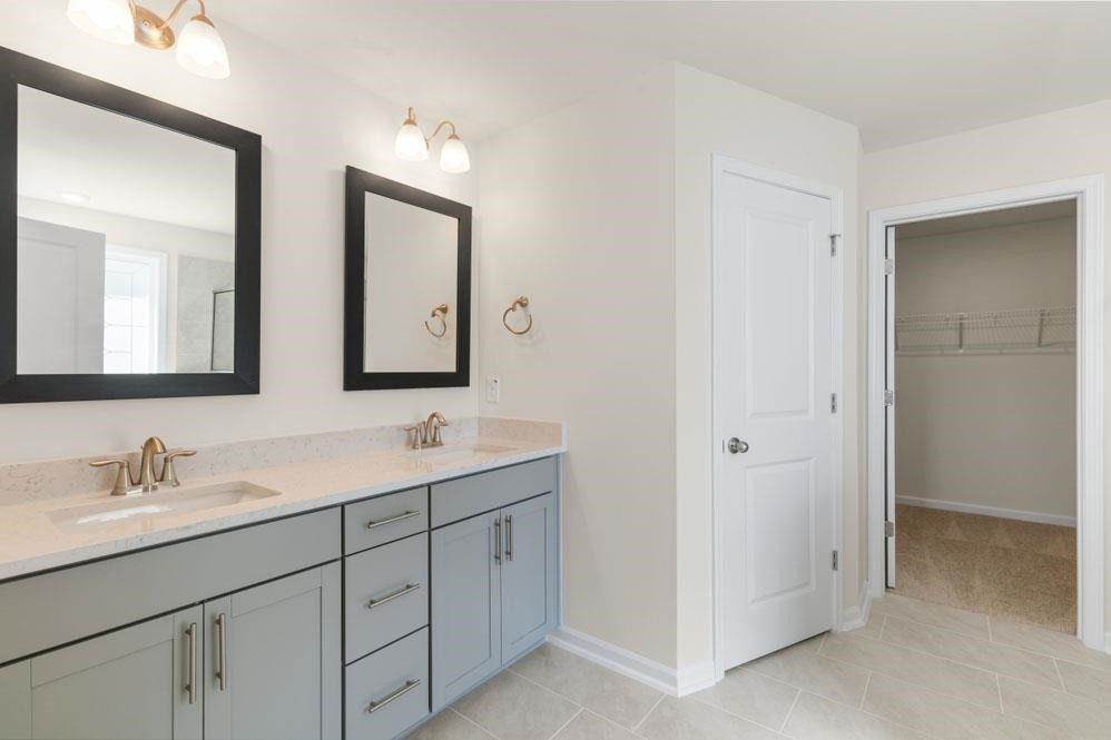 5129 Lizard Tail Lane Raleigh, NC 27603 - Photo 40 of 49 a bathroom with 2 sink and a mirror