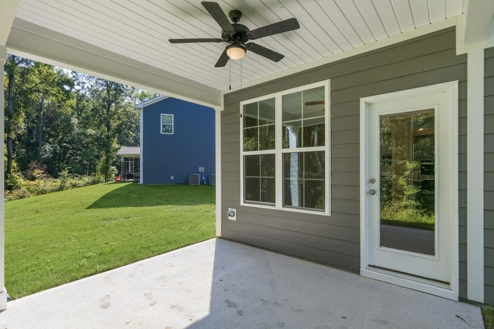 5129 Lizard Tail Lane Raleigh, NC 27603 - Photo 7 of 49 a view of a house with a large window and a yard