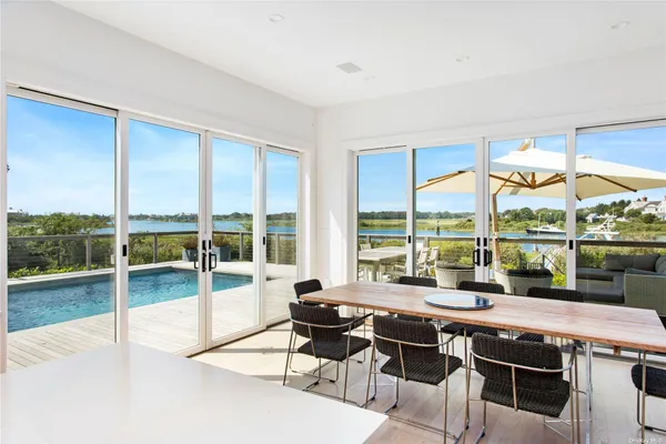 a view of a living room with furniture and floor to ceiling window
