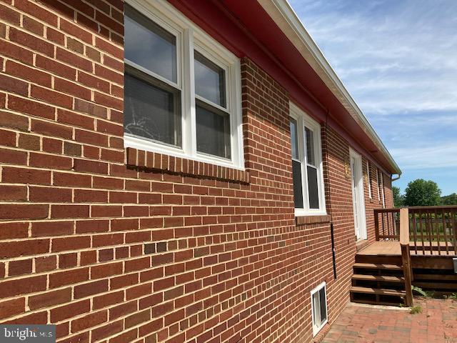 Rear of home. Back deck and brick padio.