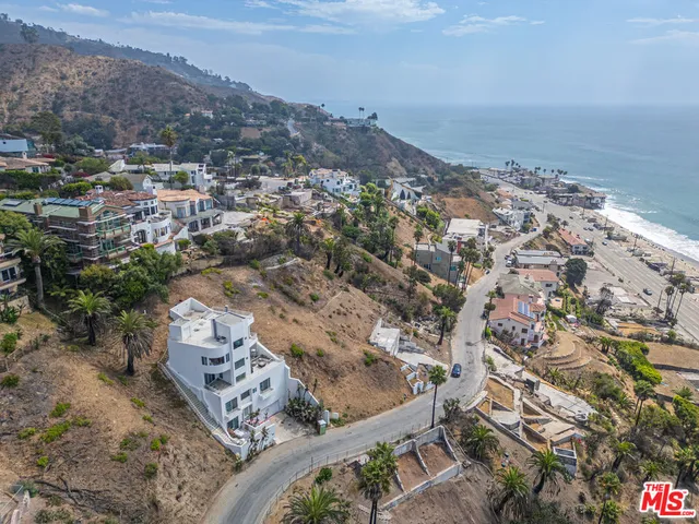 an aerial view of mountain with an ocean