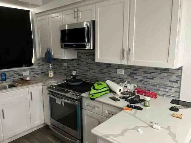 a kitchen with a sink stove and microwave