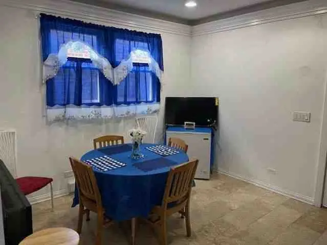 a kitchen with a wooden table and chairs