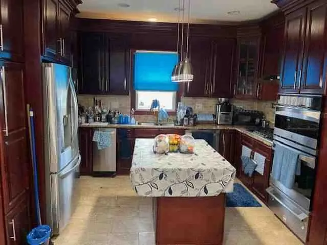 a kitchen with stainless steel appliances granite countertop a stove top oven a sink dishwasher and cabinets with wooden floor