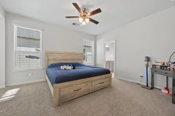 a bedroom with a bed and a ceiling fan