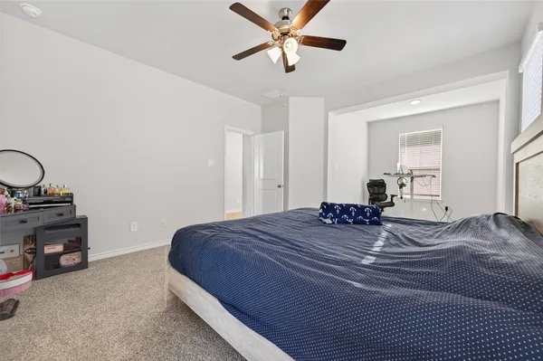 a bedroom with a bed and cabinets