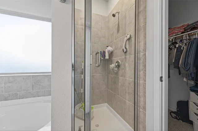 a bathroom with a shower and a glass door