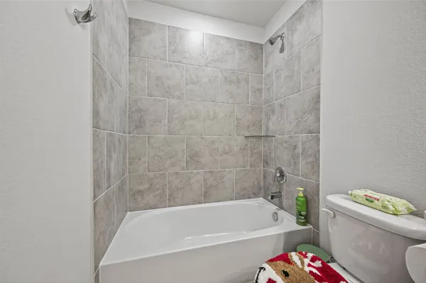 a white bath tub sitting next to a white toilet and sink