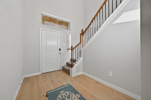 a view of an entryway with wooden floor