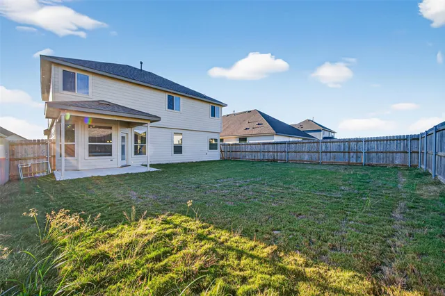 a view of a house with a backyard