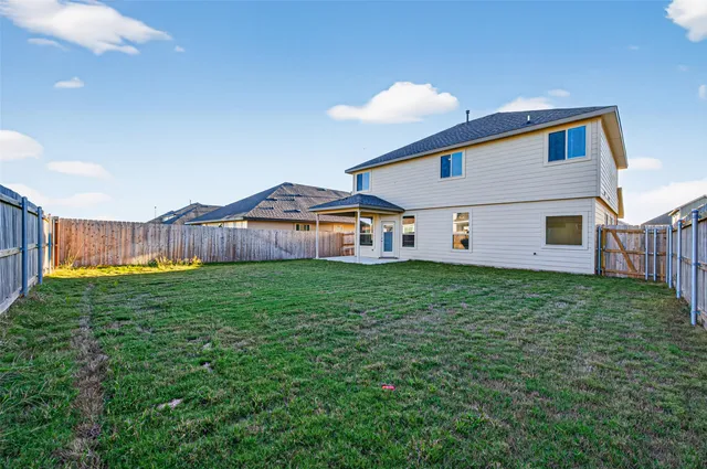 a view of a backyard with table and chairs and a yard