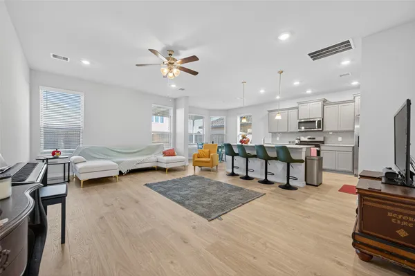 a living room with furniture and kitchen view
