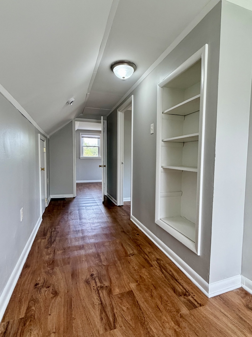 17826 School Street Lansing, IL 60438 - Photo 15 of 23 a view of empty room with wooden floor and fan
