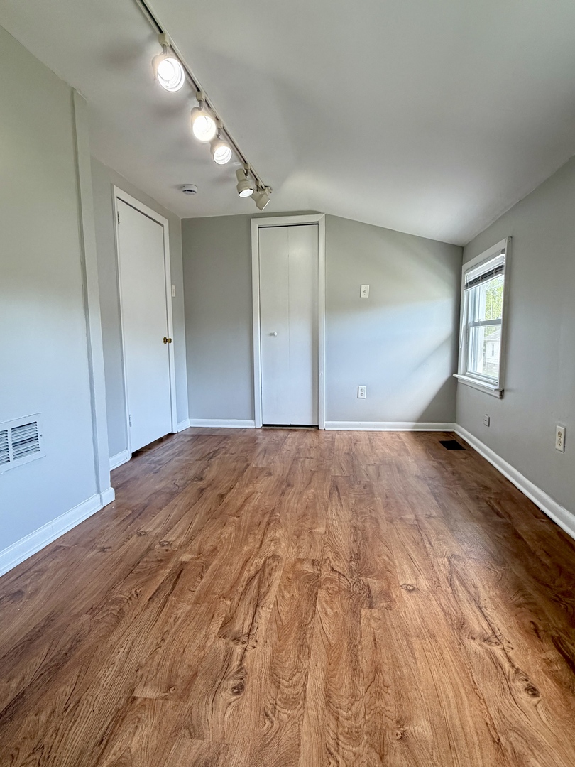 17826 School Street Lansing, IL 60438 - Photo 17 of 23 a view of empty room with wooden floor and fan