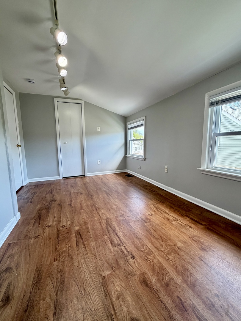17826 School Street Lansing, IL 60438 - Photo 18 of 23 wooden floor in an empty room with a window