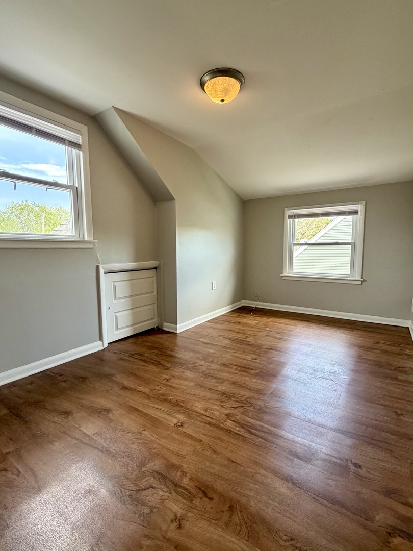 17826 School Street Lansing, IL 60438 - Photo 19 of 23 a view of empty room with wooden floor and fan