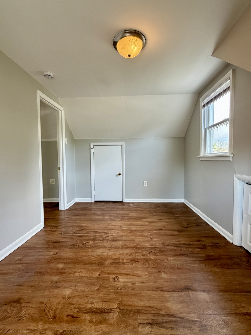 17826 School Street Lansing, IL 60438 - Photo 20 of 23 a view of a room with wooden floor and window