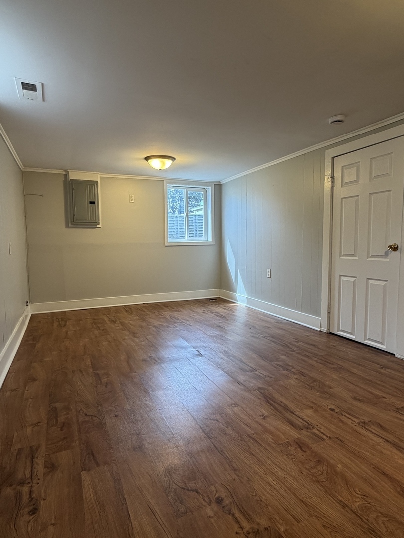 17826 School Street Lansing, IL 60438 - Photo 22 of 23 an empty room with wooden floor and windows