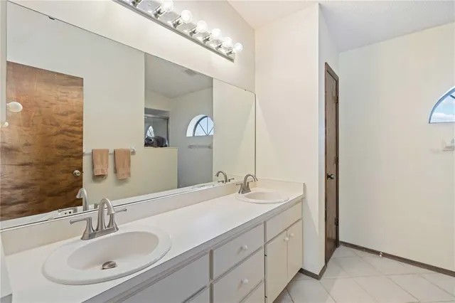 a bathroom with a double vanity sink and a mirror