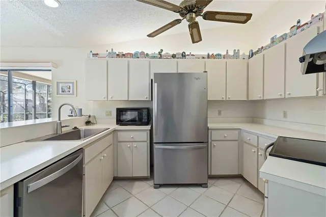 a kitchen with appliances a sink and cabinets