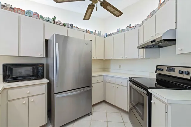 a kitchen with stainless steel appliances a refrigerator sink and microwave