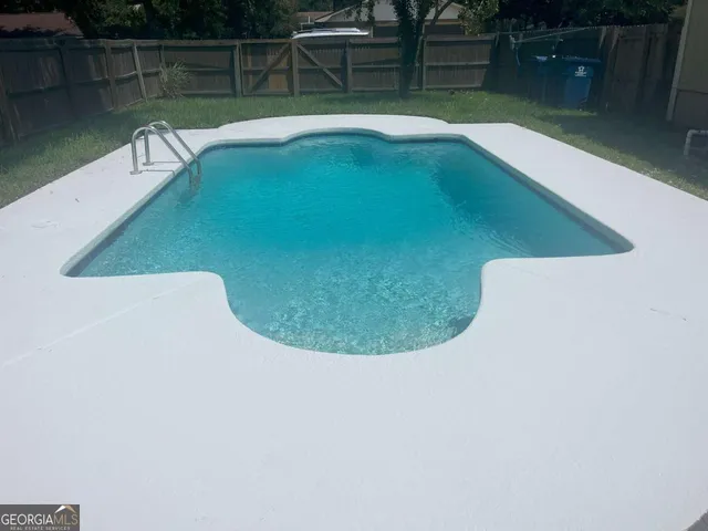 a view of a swimming pool with a yard