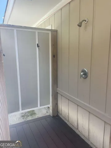 a bathroom with a glass shower door
