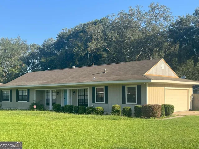 a front view of a house with a yard and porch