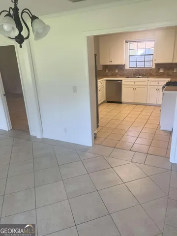 a kitchen with a sink a stove a microwave and cabinets