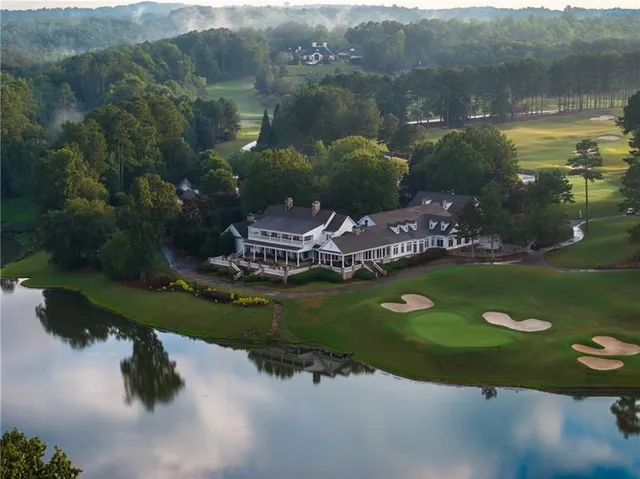 an aerial view of a house with a yard basket ball court and outdoor seating