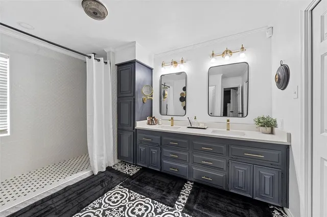 a bathroom with a double vanity sink mirror and shower