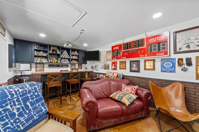 a living room with furniture a couch and a bookshelf