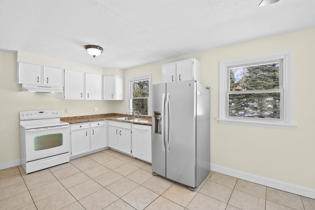 45 Bay Path Road Charlton, MA 01507 - Photo 5 of 35 a kitchen with granite countertop cabinets and refrigerator