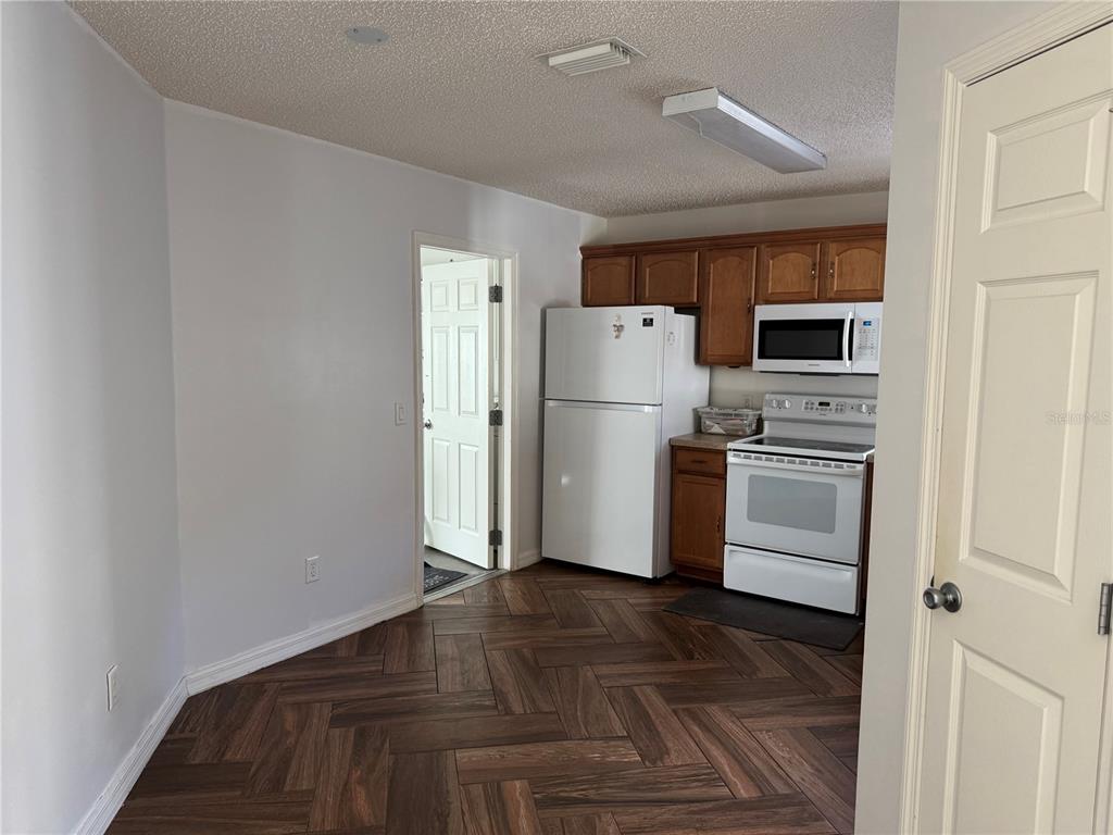 1083 Jackson Street The Villages, FL 32162 - Photo 11 of 15 a kitchen with a refrigerator a stove top oven and a refrigerator