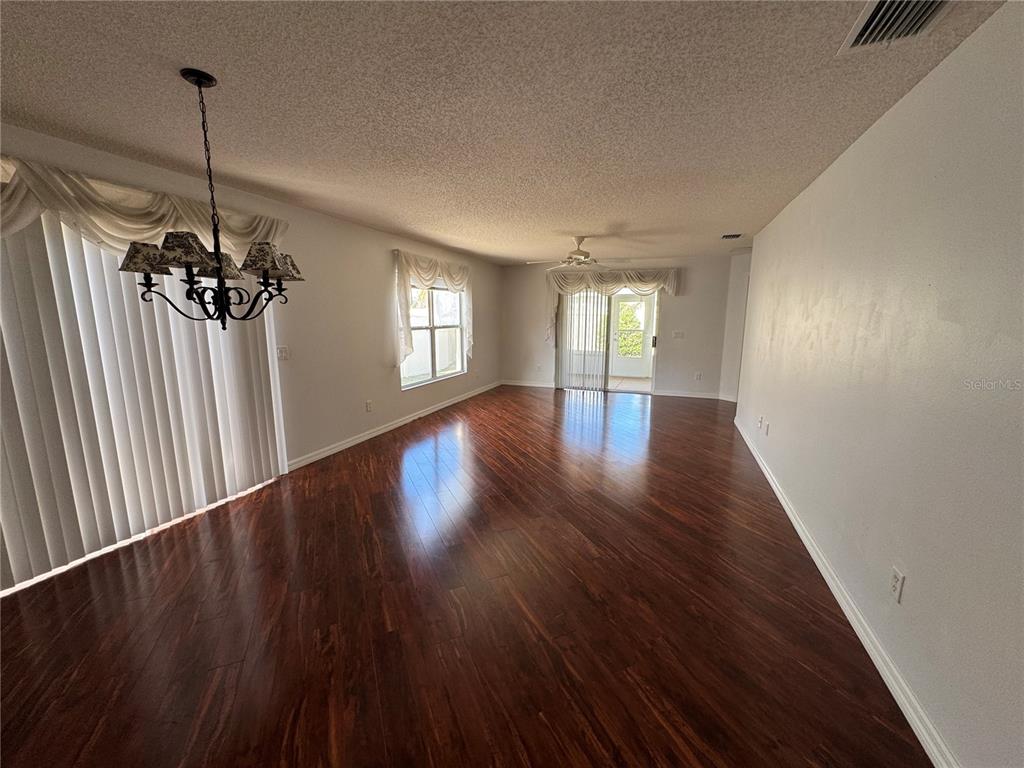 1083 Jackson Street The Villages, FL 32162 - Photo 15 of 15 a view of an empty room with a window and wooden floor