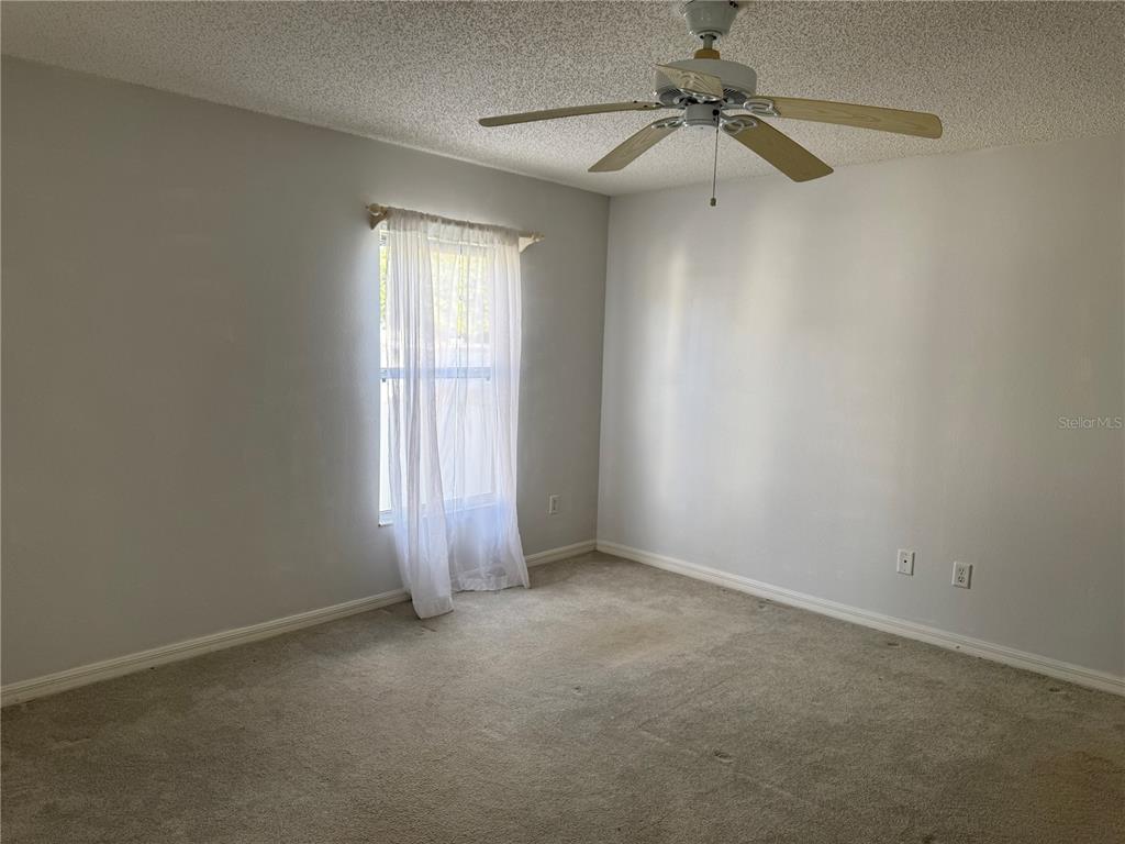 1083 Jackson Street The Villages, FL 32162 - Photo 6 of 15 an empty room with a window and a fan