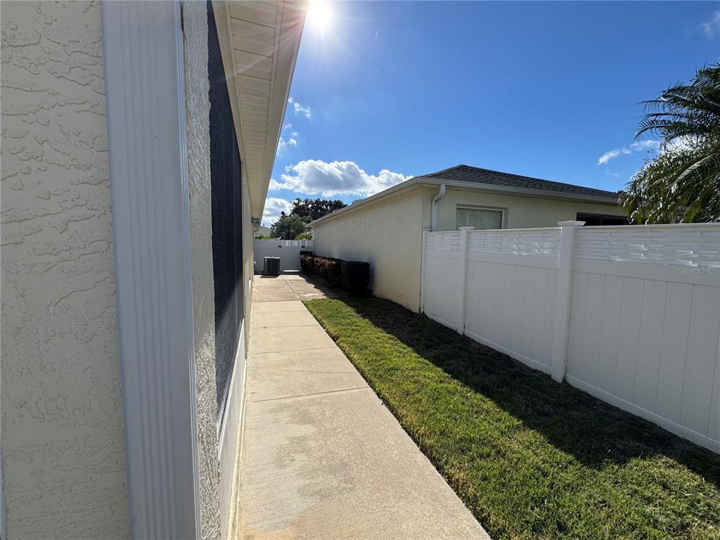 1083 Jackson Street The Villages, FL 32162 - Photo 9 of 15 a yellow house with trees in front of it