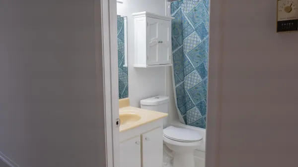 a bathroom with a sink a toilet and bathtub