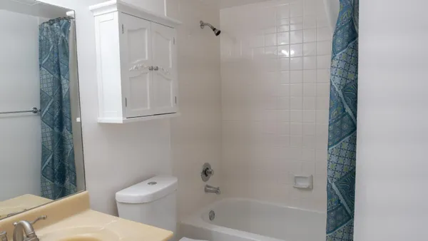 a view of entryway with bathroom and shower