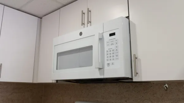 a stove top oven sitting inside of a kitchen
