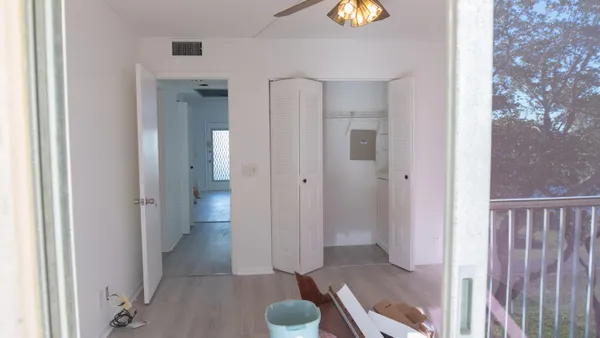a white toilet sitting next to a shower