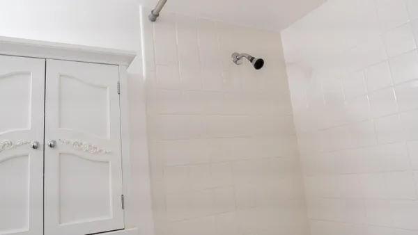 a bathroom with a toilet and a shower