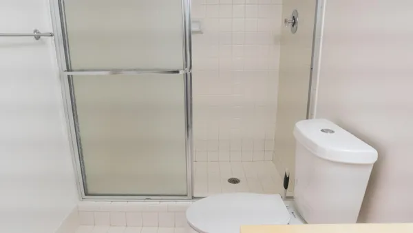 a bathroom with a shower a toilet and a shower