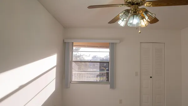 a view of staircase with white walls and a window