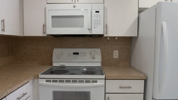 a kitchen with granite countertop a sink and a stove