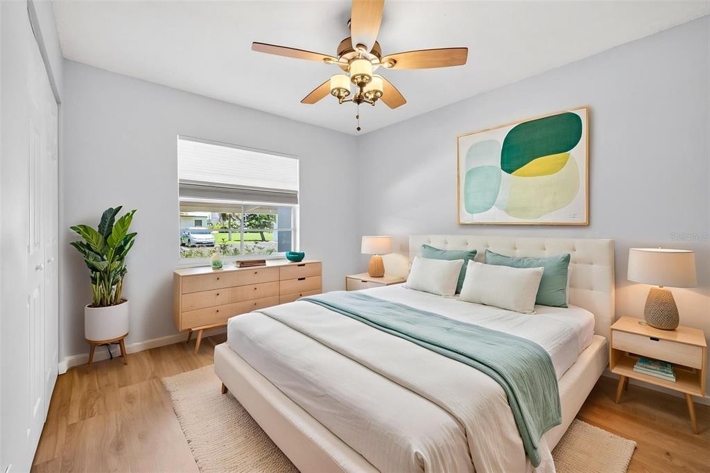 5197 Silent Loop, Unit 124 New Port Richey, FL 34652 - Photo 26 of 55 a bedroom with a bed and a potted plant