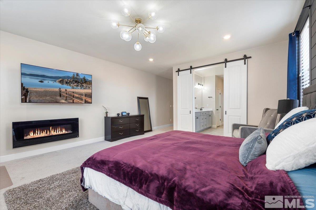 2711 McCauley Ranch Boulevard Reno, NV 89521 - Photo 19 of 40 a spacious bedroom with a bed dresser and a large mirror