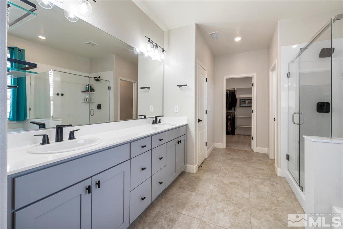 2711 McCauley Ranch Boulevard Reno, NV 89521 - Photo 22 of 40 a spacious bathroom with double vanity and mirrors